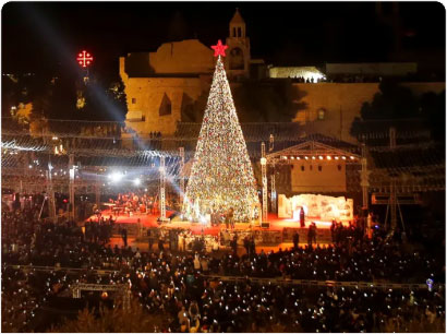 Palestinians light Christmas tree in Manger Square outside the Church of the Nativity in Bethlehem, November 30, 2019